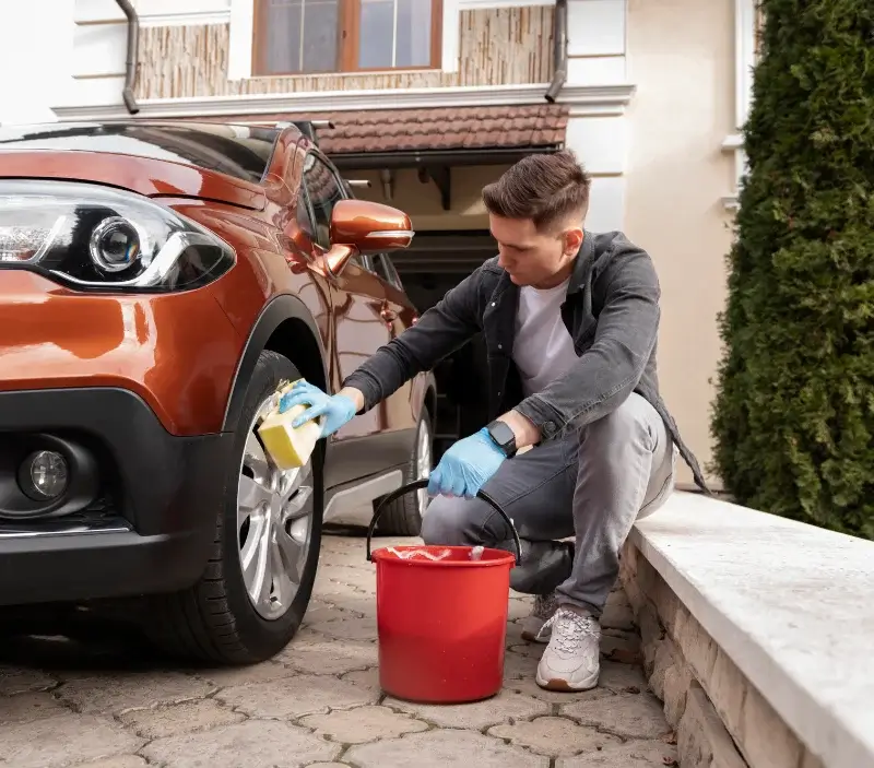Lavage auto à domicile Taillebourg : professionnel intervenant sur un véhicule